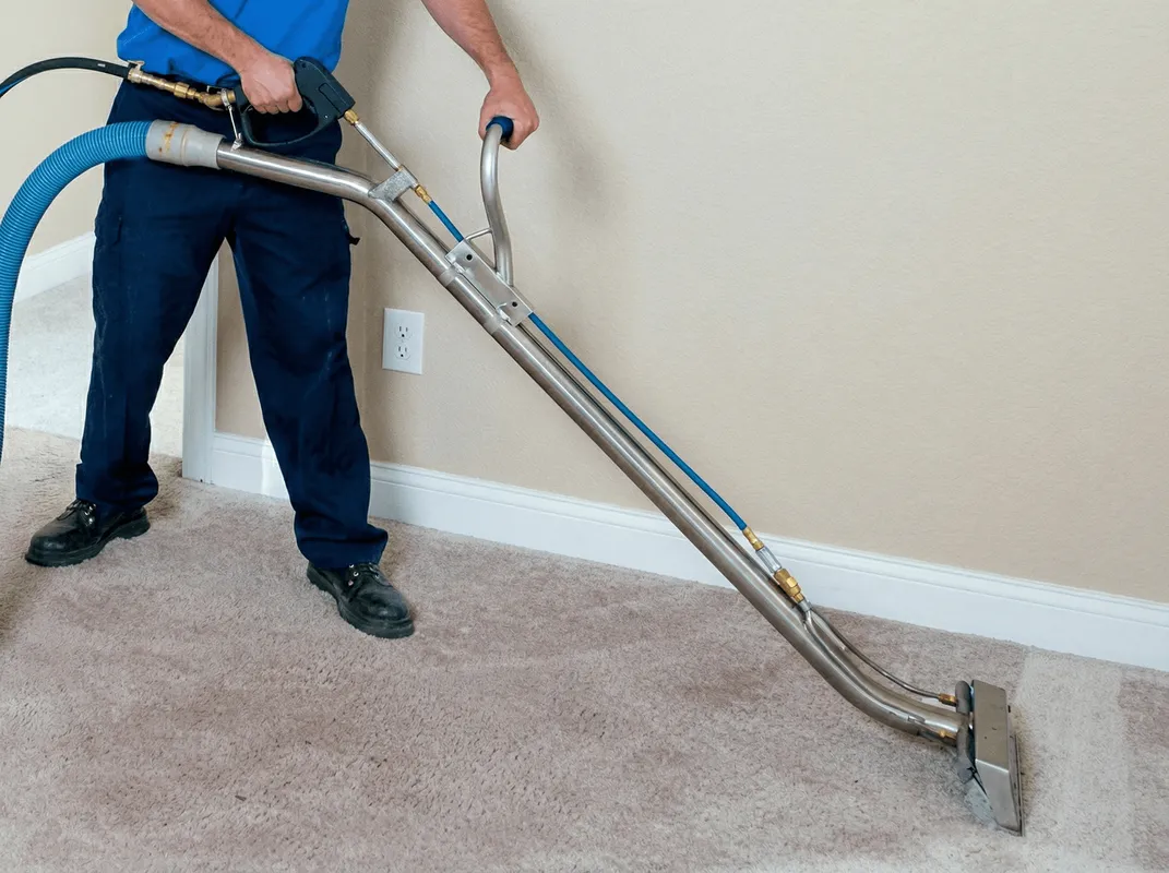 Professional operating a liquid removal machine on a carpeted floor in Mesa, AZ